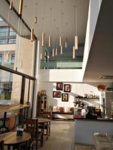 a restaurant with tables and chairs in a room at Embassy Gardens Luxury Apartments in Accra