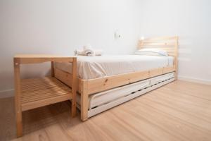 a bedroom with a wooden bed with a desk at Apartamento Colon en Cadiz in Cádiz
