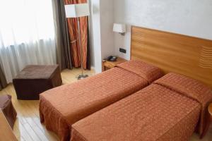 Postel nebo postele na pokoji v ubytování Hotel Continental