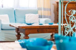 a living room with a table with blue bowls on it at Costa Dorada in Cala Gonone