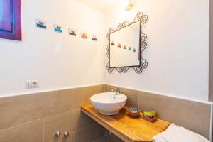 a bathroom with a sink, toilet and bathtub at Hotel Ristorante S'Ortale in Orosei
