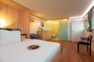 a bedroom with a bed with a bowl of flowers on it at Business Apartment in Schwarzach