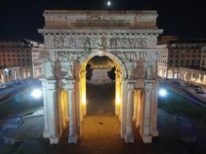 an arch in a city at night with lights at Domus Victoria in Genova
