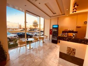 a lobby with a table and chairs and a parking lot at Al Hayat Al Marina Suites in Tabuk