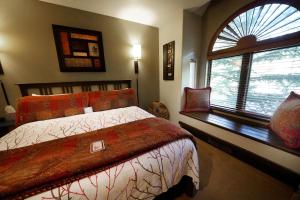 a bedroom with a bed and a large window at Frisco Inn on Galena in Frisco