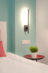 a bedroom with a bed and a table with a potted plant at ABAL Apartments - Barrio in Alicante +207 photos