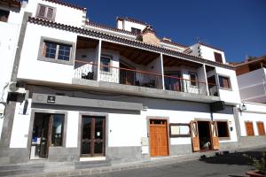 a white building with a balcony on a street at VACACIONAL LA TEA THE BEST LOCATION and THE BEST VIEWS in Tejeda