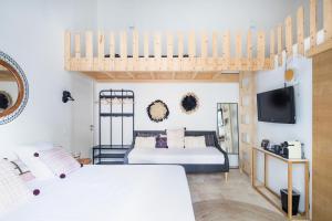 a bedroom with two beds and a loft bed at Le 104 Feuvrier in Dole