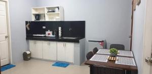 a kitchen with a table and a counter with chairs at Apple Transient House in Angeles