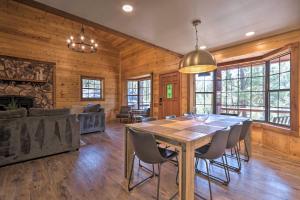 a dining room with a wooden table and chairs at Modern Pine Cabin with Game Room, Deck and Fire Pit! in Pine