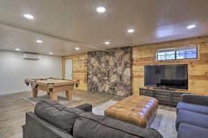 a living room with a pool table and a tv at Modern Pine Cabin with Game Room, Deck and Fire Pit! in Pine