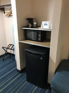 a room with a microwave and a trash can at Days Inn by Wyndham Panama City in Panama City