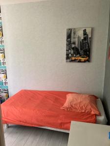 a bedroom with a red bed with a picture on the wall at BEAUN'MAISON Spa Piscine Borne électrique in Beaune