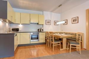a kitchen with a table and a dining room at Apart La Vita in Sankt Anton am Arlberg