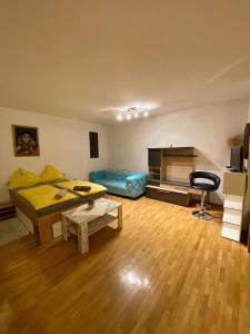 a living room with a bed and a table at Rathausstüberl in Bad Radkersburg