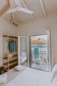 a bedroom with a bed and a view of the ocean at ERIEL Boutique Apartments in Lefkada Town