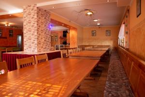 a dining room with wooden tables and chairs at Turistična kmetija Sirk in Zgornja Velka