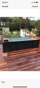 a hot tub on top of a wooden deck at Villa des Chardons in Yport