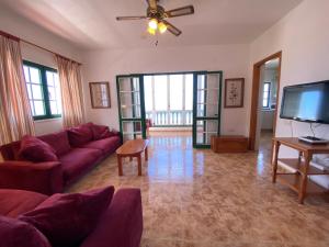 a living room with a couch and a flat screen tv at CASA PACO Y NINA in Frontera