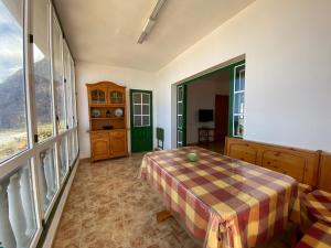 a bedroom with a table and a large window at CASA PACO Y NINA in Frontera