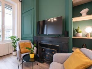 een woonkamer met een open haard en een televisie bij Luxury Studio "Le Chaleureux" - Lyon Part-Dieu - Dreamy Flat Lyon in Lyon