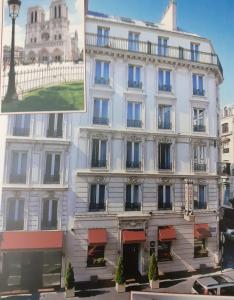 un gran edificio blanco con toldos rojos en Home Latin en París