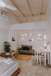 a living room with a table and a couch at ERIEL Boutique Apartments in Lefkada Town