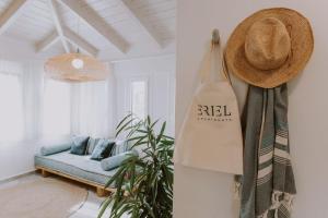 a room with a couch and a hat on a wall at ERIEL Boutique Apartments in Lefkada Town