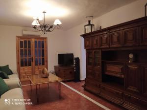 a living room with a large wooden entertainment center at Casa "El Limonero", Peñuelas,Granada in Trasmulas