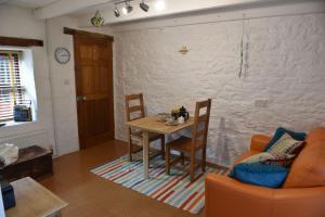 a living room with a table and a chair at Delfryn Guest Suite in Haverfordwest