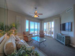 a living room with a couch and a flat screen tv at Crescent IV in Destin