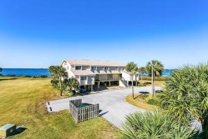an aerial view of a house with the ocean in the background at Santa Rosa Dunes in Pensacola Beach