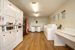 a laboratory with white appliances in a room at HomeTowne Studios by Red Roof Philadelphia-Maple Shade, NJ in Maple Shade