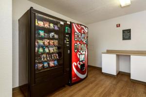 a cocacola soda vending machine in a room at HomeTowne Studios by Red Roof Philadelphia-Maple Shade, NJ in Maple Shade