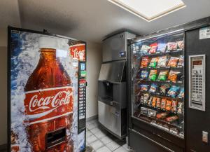 a refrigerator with a bottle of coke and other drinks at Red Roof Inn Washington, PA in Washington