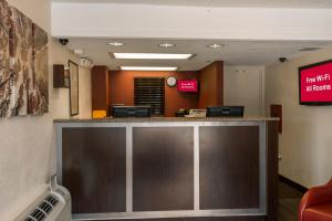 a lobby with a reception counter in a hospital at Red Roof Inn PLUS+ St. Louis - Forest Park / Hampton Ave. in Saint Louis