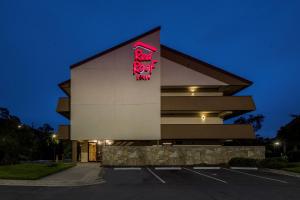 a building with a red sign on the side of it at Red Roof Inn Tampa - Brandon in Tampa