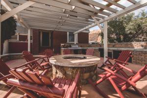 a patio with chairs and a table with a tree stump at Greenway Manor in Bisbee