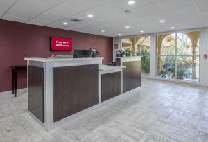 an office lobby with a reception desk with a sign on the wall at Red Roof Inn Tampa Bay - St. Petersburg in St. Petersburg