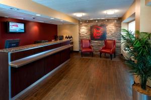 a lobby of a hotel with red chairs and a bar at Red Roof Inn PLUS+ Philadelphia Airport in Essington