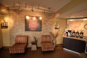 a bar with two chairs and a brick wall at Red Roof Inn Lafayette, LA in Lafayette