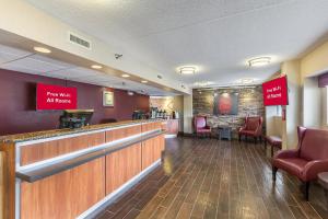 a lobby of a hotel with a bar and chairs at Red Roof Inn Minneapolis Plymouth in Plymouth