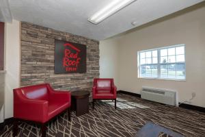 a living room filled with furniture and a red wall at Red Roof Inn Springfield, MO in Springfield