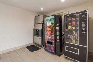 two refrigerators are standing next to each other in a room at Red Roof Inn Fort Worth South in Fort Worth