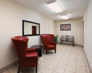 a room with chairs, tables, and chairs in it at Red Roof Inn PLUS+ South Deerfield - Amherst in South Deerfield
