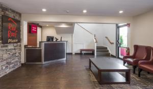 a lobby with a waiting room with a table and chairs at Red Roof Inn PLUS+ Poughkeepsie in Poughkeepsie