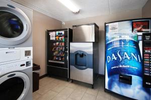 a kitchen with a refrigerator and a washing machine at Red Roof Inn PLUS+ Nashville Fairgrounds in Nashville