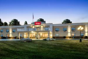 a hotel with two large rocks in front of it at Red Roof Inn & Suites Newburgh - Stewart Airport in New Windsor