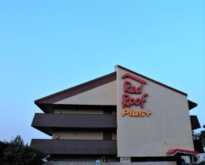 a red roof plus sign on the side of a building at Red Roof PLUS Chicago - Hoffman Estates in Hoffman Estates