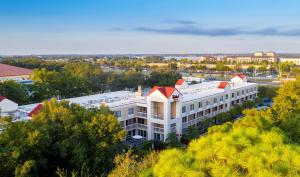 
a large building with a large clock tower at Red Roof Inn PLUS+ Orlando - Convention Center / Int'l Dr in Orlando

